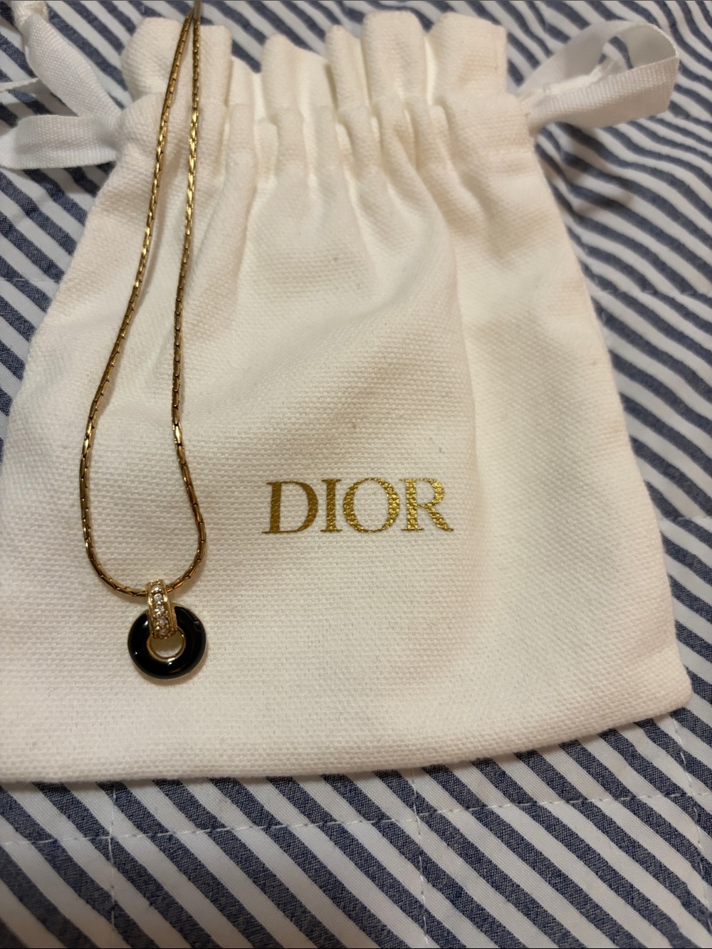 Dior 17 inch gold plated necklace, black donut  shaped charm with crystal accent